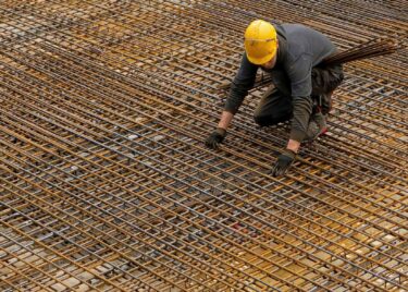 Man on roof with scaffolding - ESG Standards and Frameworks for the Mining Industry