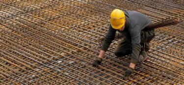 man on roof with scaffolding esg standards and frameworks for the mining industry2
