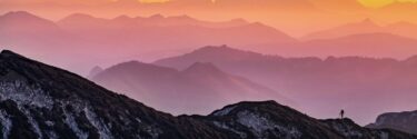 hiker on a mountain at sunset