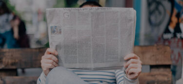 person reading a news paper