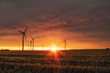 sunset behind turbines