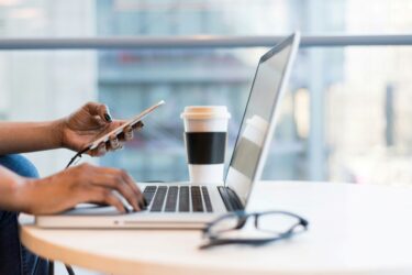 Corporate Sustainability Due Diligence Directive a person working remotely with their phone and laptop
