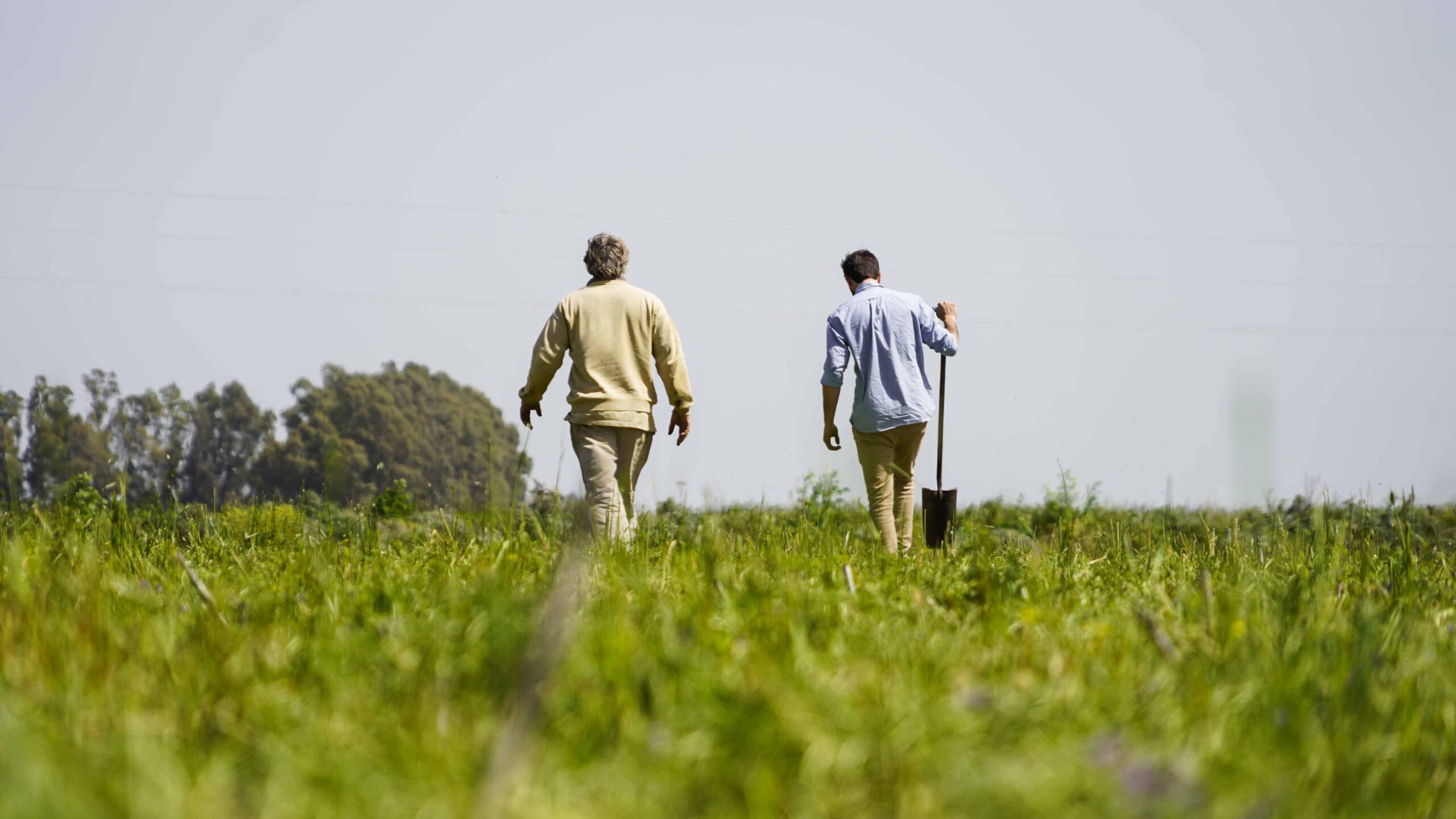 two men walking on the field