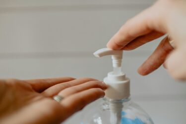 5 Reasons Businesses Should Target Food Waste Reduction to Achieve Sustainable Performance hands using a pump bottle