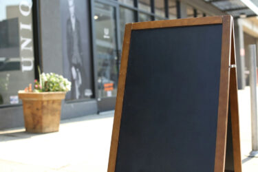 CBAM Financial Impacts in 2026: What Your Business Needs to Know Now aframe sign outside of a shop