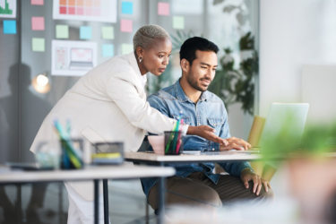 two people working on a laptop