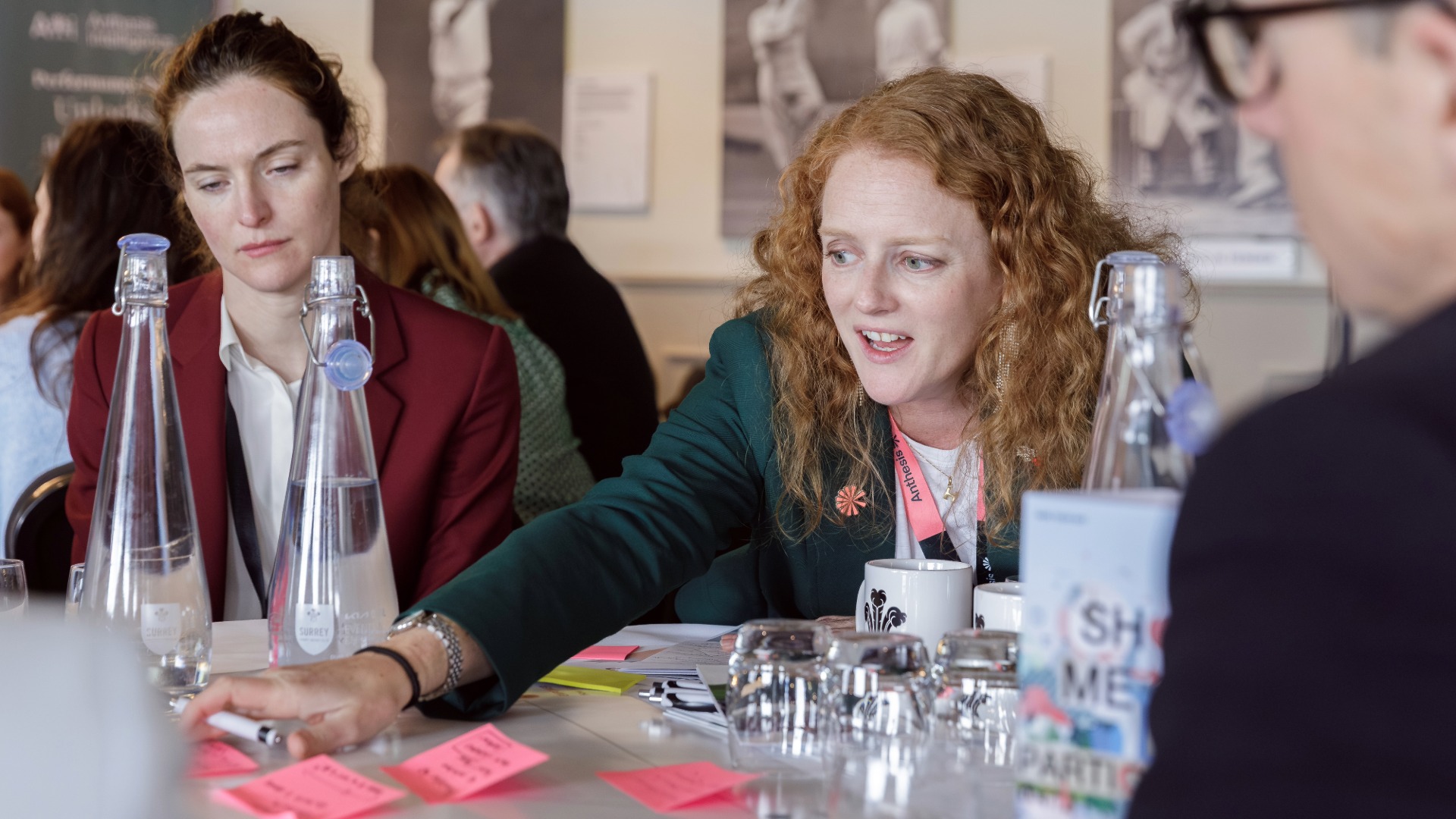 Anthesis Activator Summit: Show Me the Performance A woman facilitating discussion at a table