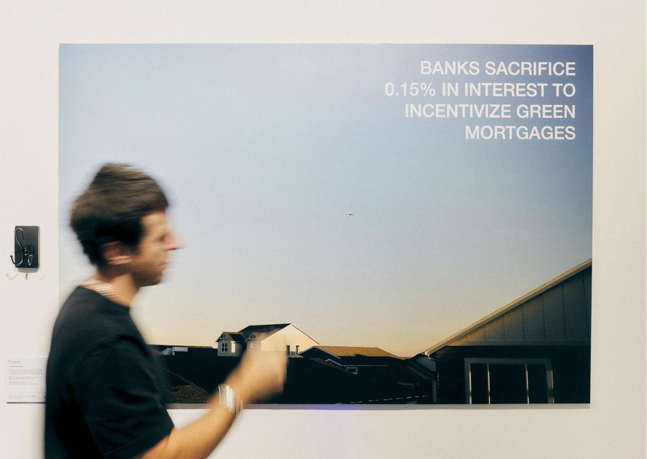 Image on wall with man walking past