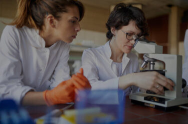 scientists using a microscope