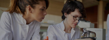 scientists using a microscope